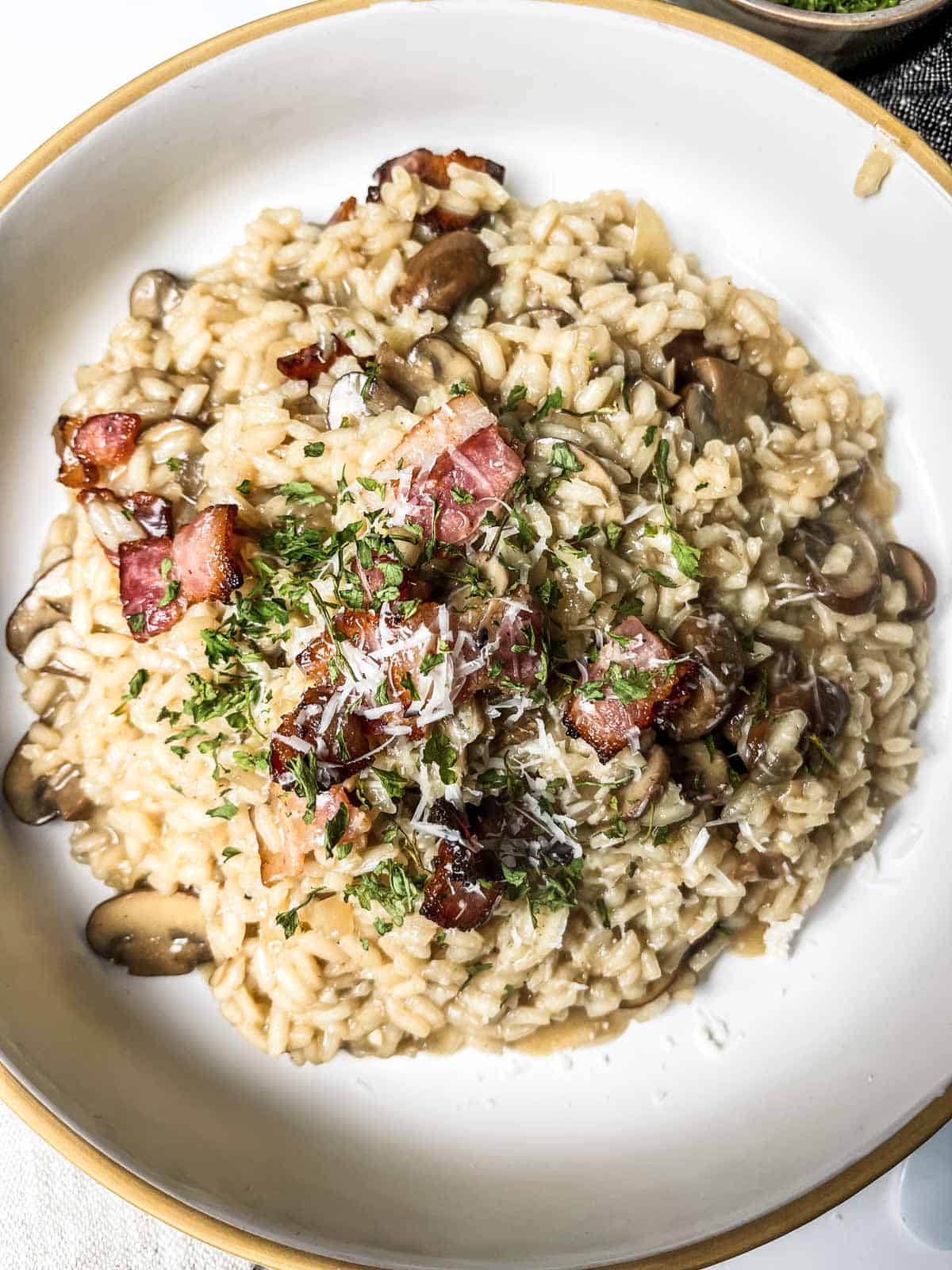 Bacon and mushroom risotto in bowl.