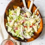 stl salad in a bowl with tongs.