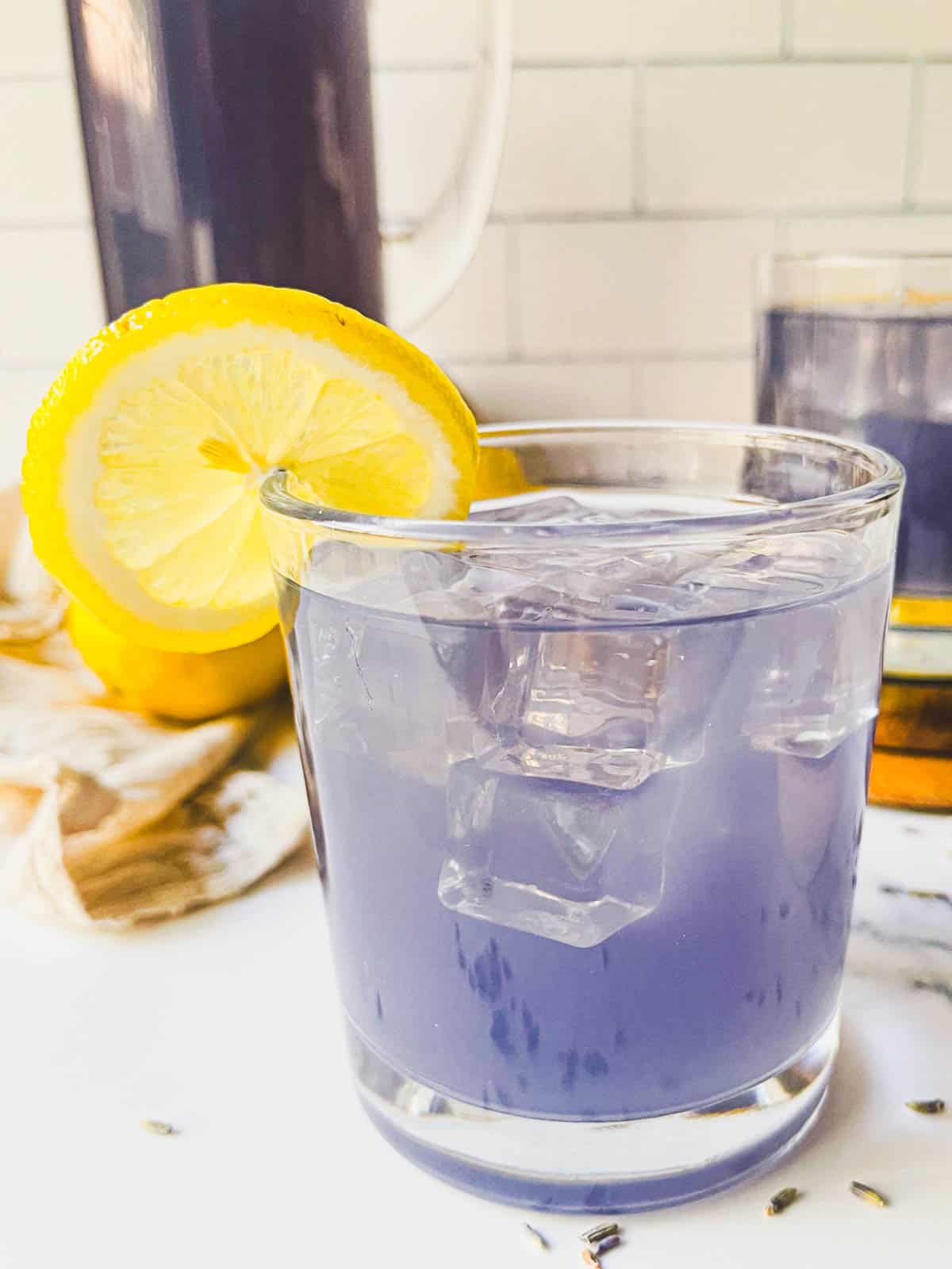 lavender lemonade served with a lemon.