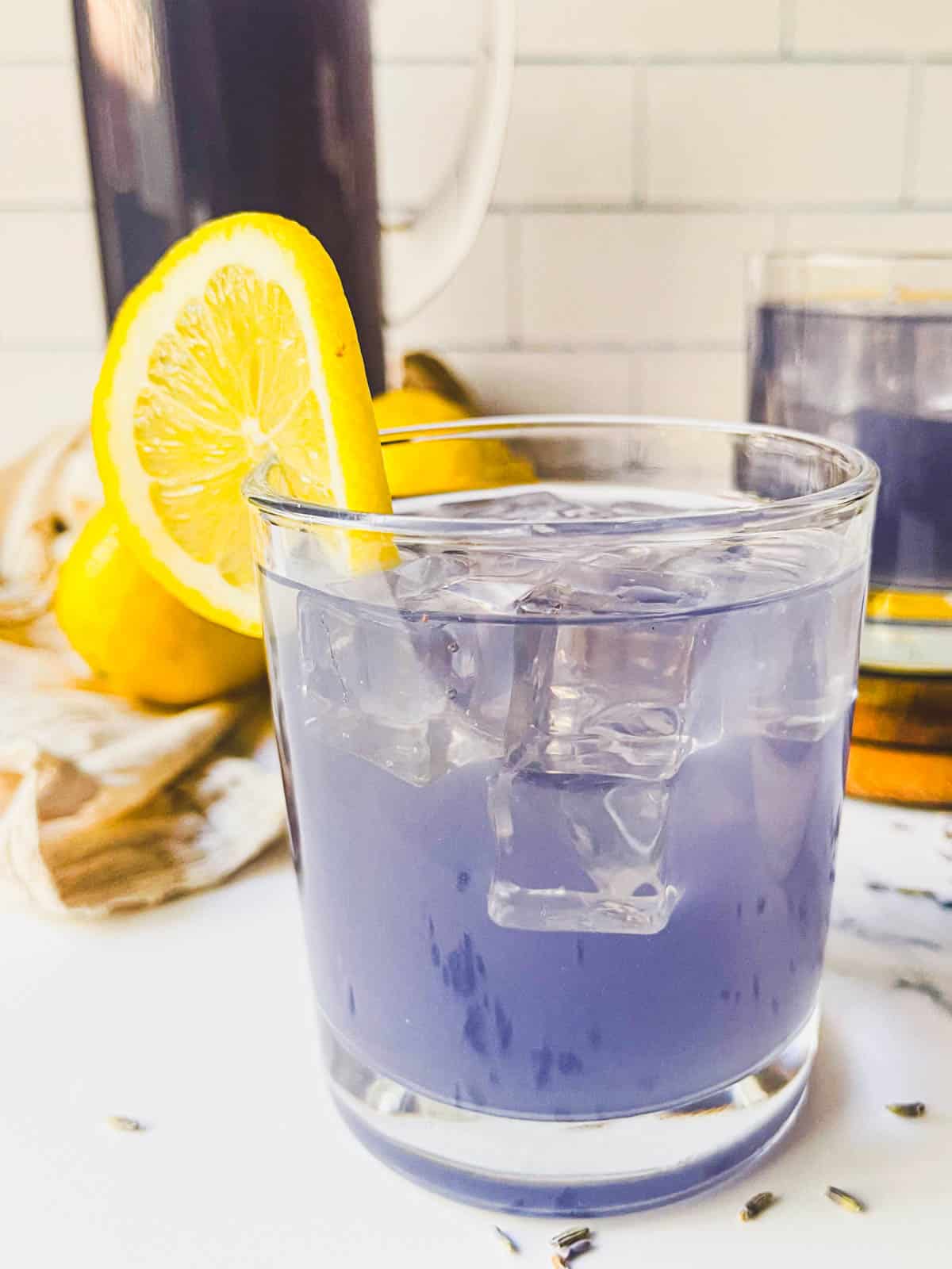 lavender lemonade served with a lemon. 