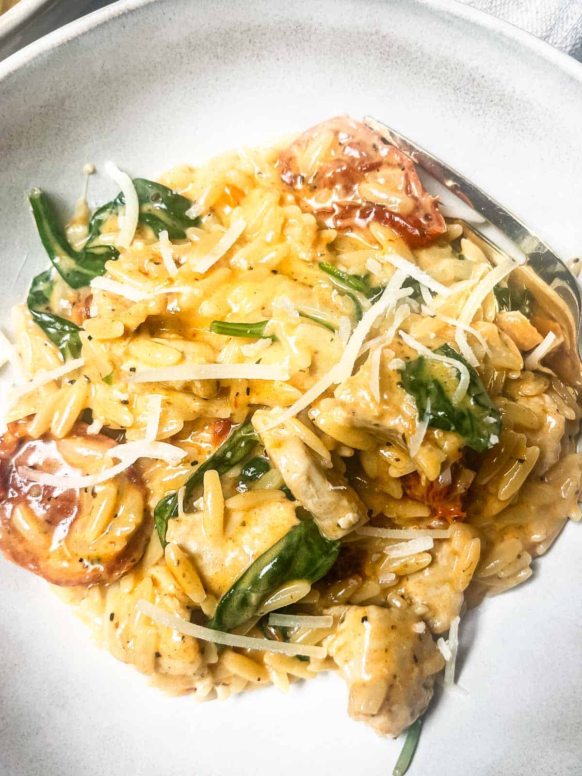 Chicken Orzo Pasta Bake garnished with cheese.