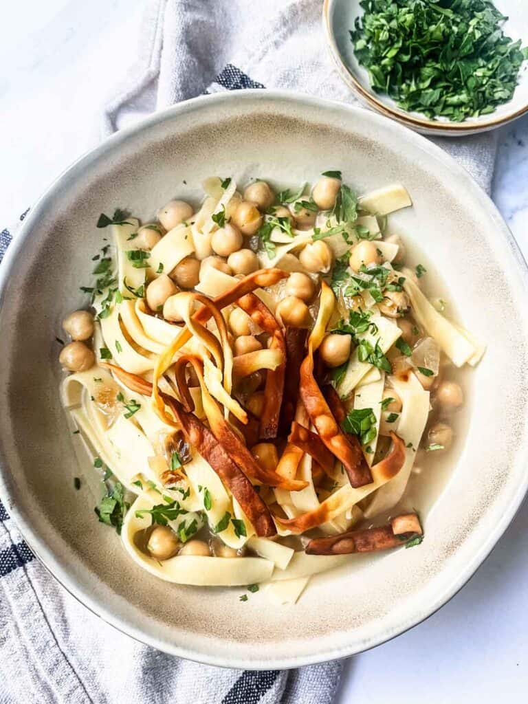 Ciceri e tria garnished with parsley.