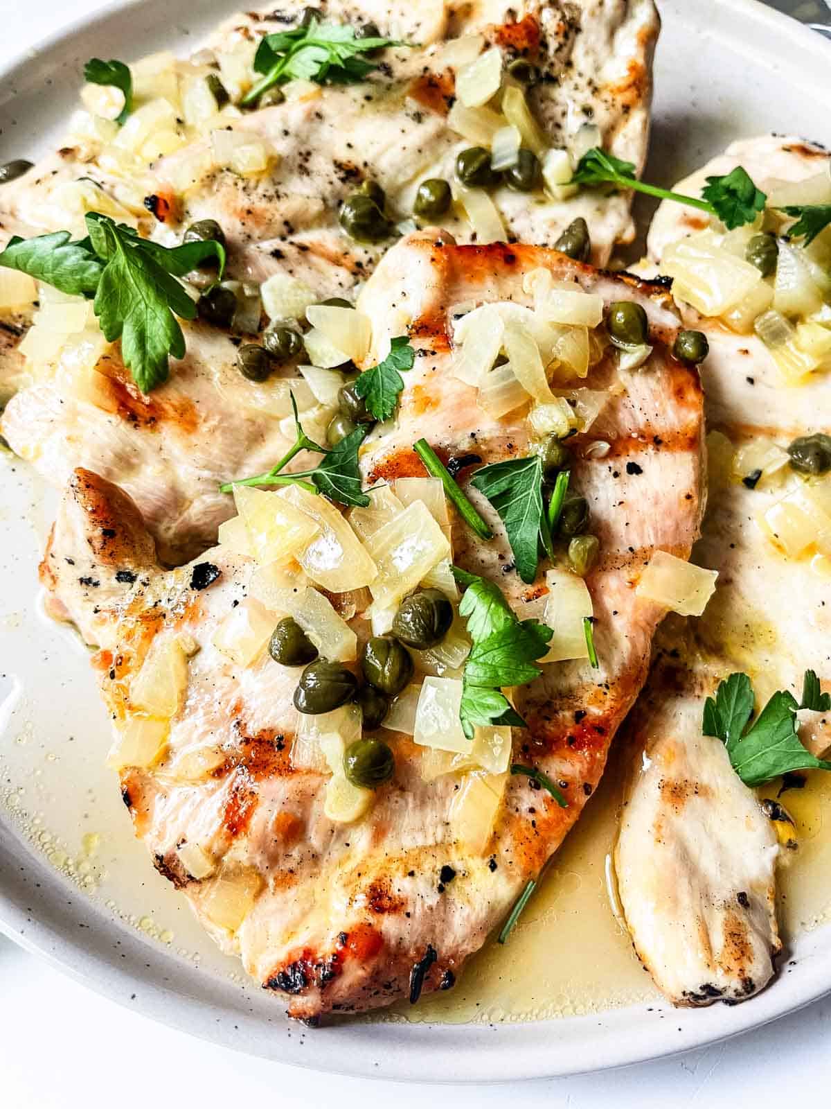 Grilled Chicken Piccata served on a plate.