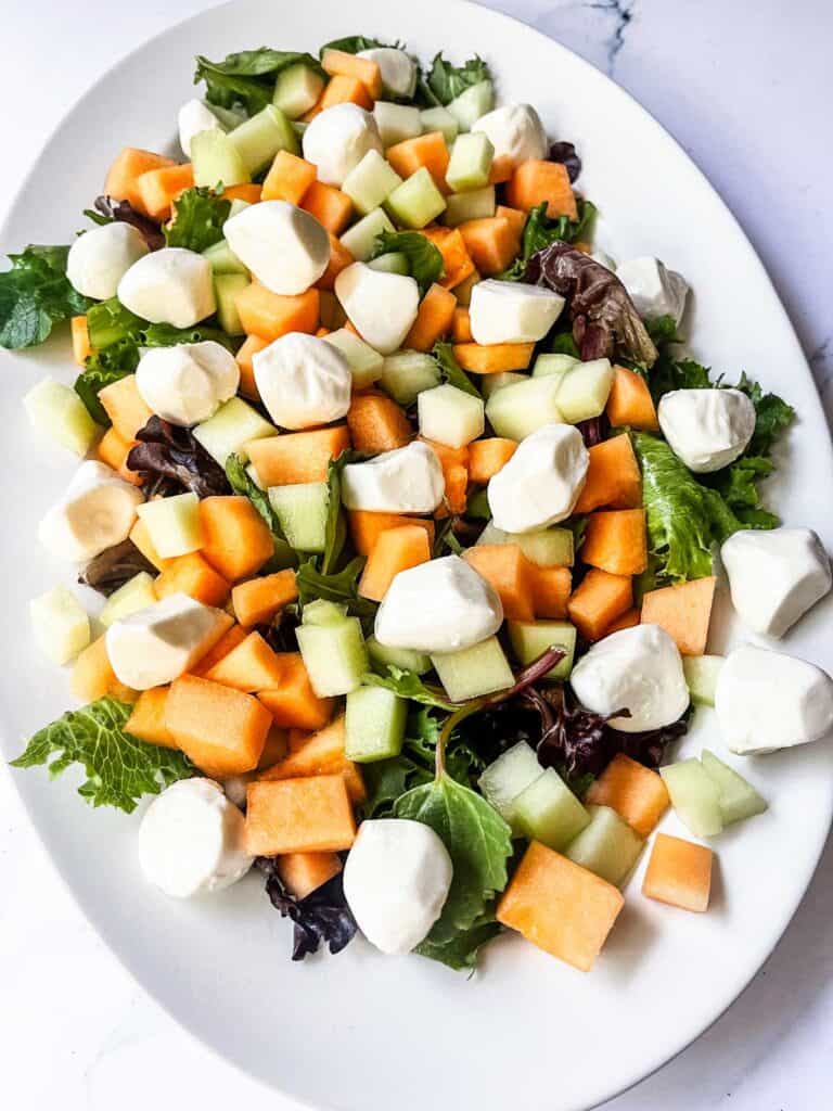 Mozzarella added to salad.