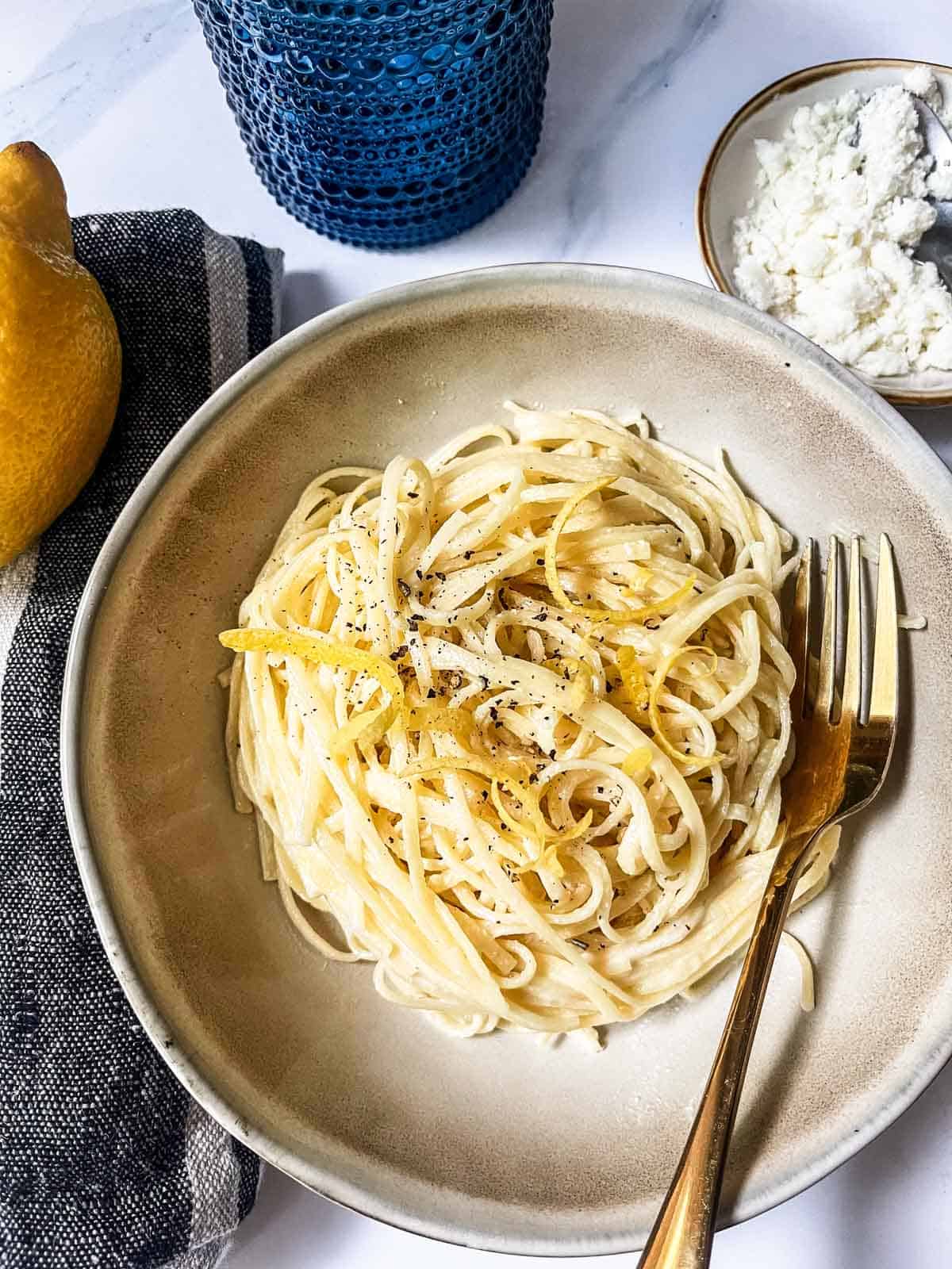 Tagliolini al limone with a lemon on the side.